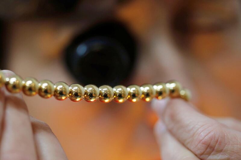An employee checks a gold bracelet in a jewellery shop in Bordeaux, France, December 9, 2017. REUTERS/Regis Duvignau
