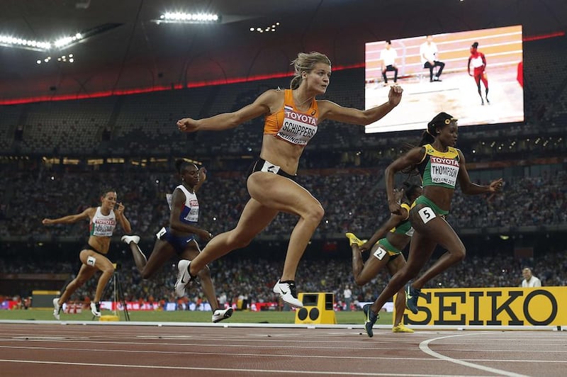 The Netherlands’ Dafne Schippers, centre, crosses the finish line in 21.63 seconds, a European record, to win the women’s 200-metre sprint yesterday at Beijing. Adrian Dennis / AFP