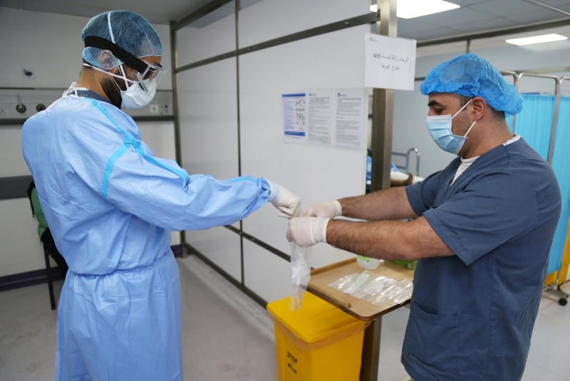 A doctor, wearing protective gear, handles a test for the coronavirus disease (COVID-19), at Rafik Hariri University Hospital, in Beirut, Lebanon October 1, 2020. Picture taken October 1, 2020. REUTERS/Issam Abdallah