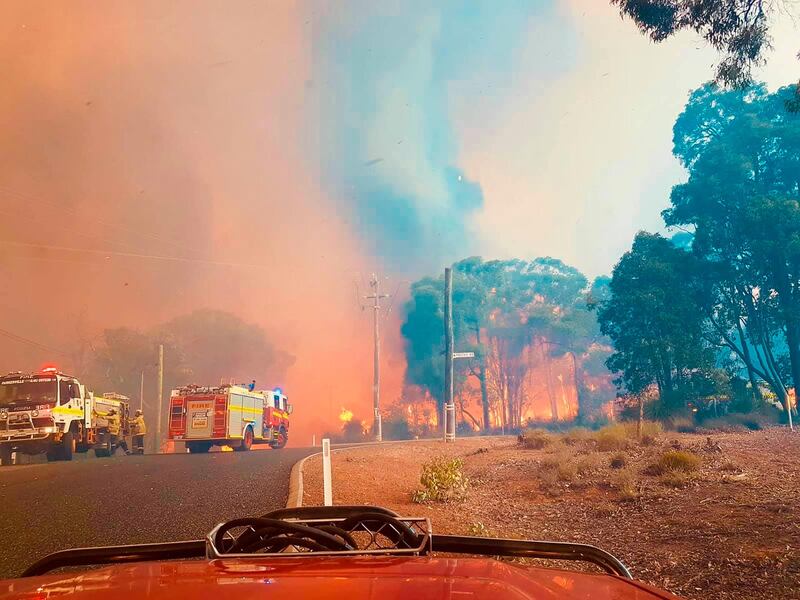 Firefighters attend a fire at Wooroloo, near Perth. AP