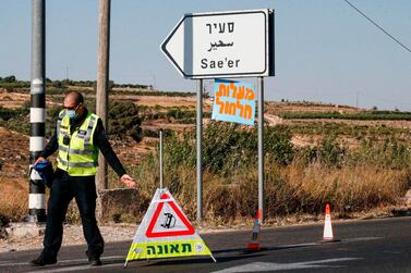 An Israeli policeman at a junction near the Palestinian village of Halhul, north of Hebron in the West Bank. AFP