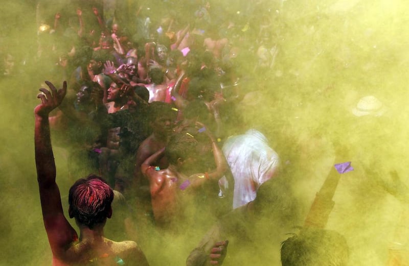 Men dance as coloured powder is sprayed on them during Holi celebrations in Allahabad. Jitendra Prakash / Reuters