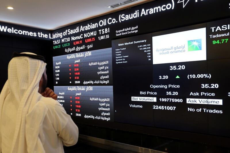 An investor monitors a screen displaying stock information at the Saudi Stock Exchange (Tadawul) following the debut of Saudi Aramco. Reuters