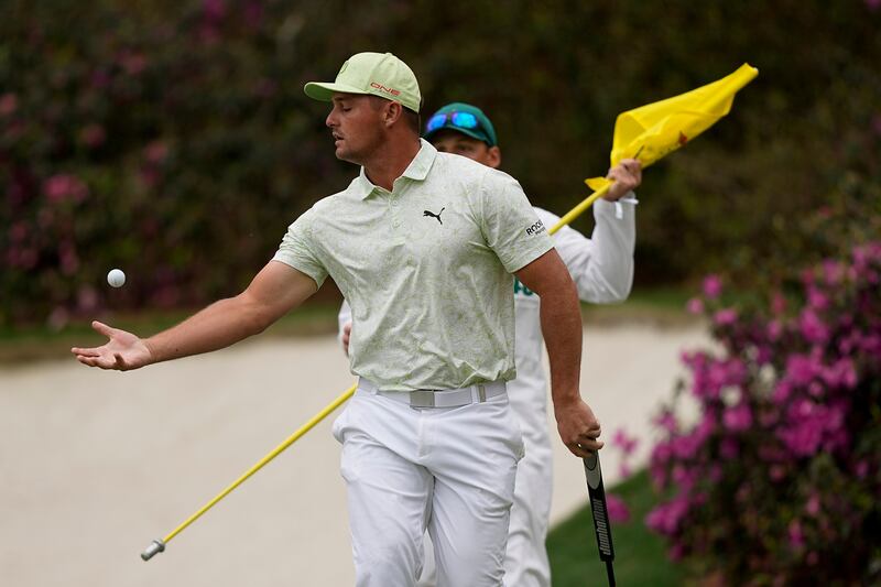 Bryson DeChambeau catches his ball after putting on the 13th green during his second round at the Masters on April 8, 2022, AP 