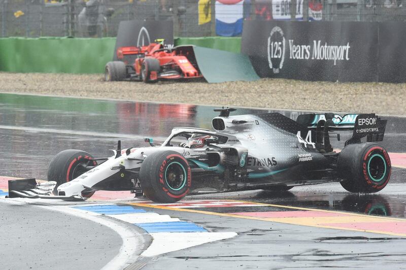 Hamilton rejoins the track after his crash as Leclerc's car sits in the barriers behind. AFP