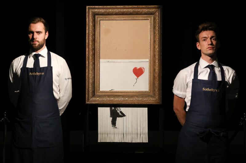 Sotheby's unveils Banksy's newly-titled Love is in the Bin in London, England. Getty Images