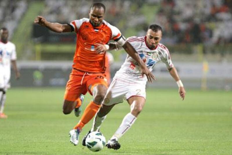 Dubai, United Arab Emirates, May 14, 2013 - Boris Kabi(left), from Ajman, fight for the ball against Khalid Sabeal, from Al Jazira, during the Pro League Etisalat Cup final at Al Wasl's Zabeel Stadium. ( Jaime Puebla / The National Newspaper ) 