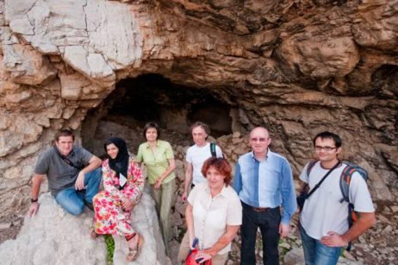 Dr. Asma Al Ketbi(seated), Head of Emirates Geographic Society and Geography Professor at UAE University with a group of cave experts at the Karst Research Institute from Slovenia at the site of a cave in Ras Al Khaimah, United Arab Emirates on Wednesday, Jan. 26, 2011. Photo: Charles Crowell for The National