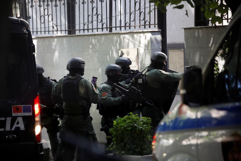 Armed police officers enter the embassy after Albania cut ties with Iran over a cyber attack. Reuters