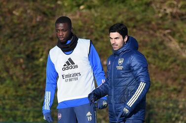 Arsenal manager Mikel Arteta with Nicolas Pepe during a training session. Getty