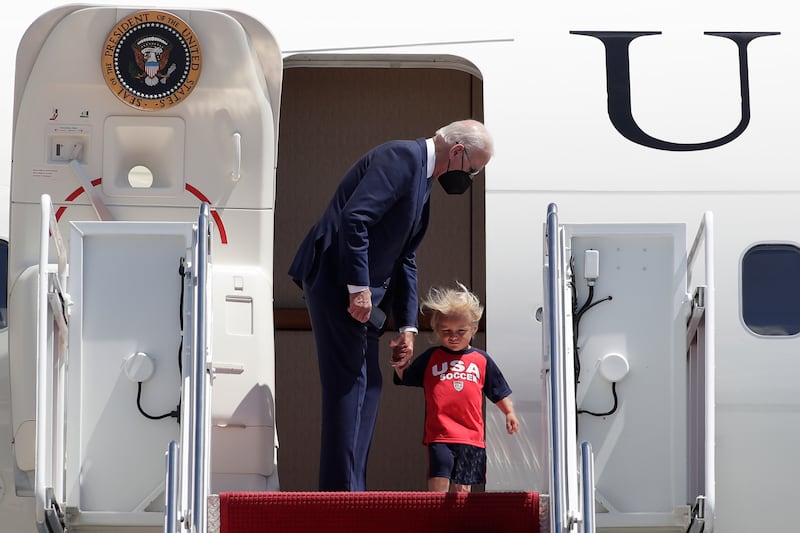 Mr Biden walks with grandson Beau upon their return to Washington. AP