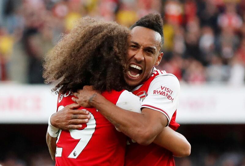 Arsenal's Pierre-Emerick Aubameyang celebrates scoring their second goal against Tottenham Hotspur with teammate Matteo Guendouzi. Reuters