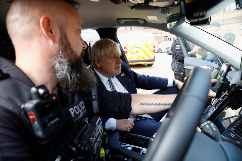 Mr Johnson views an armed response vehicle during a visit with members of Thames Valley Police at Milton Keynes Police Station. Getty Images