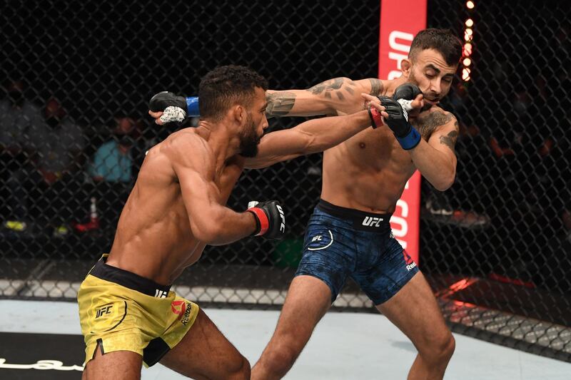 Edson Barboza (L) of Brazil punches Makwan Amirkhani of Finland in their featherweight bout during the UFC Fight Night event inside Flash Forum on UFC Fight Island in Abu Dhabi, United Arab Emirates. Josh Hedges/Zuffa LLC via Getty Images