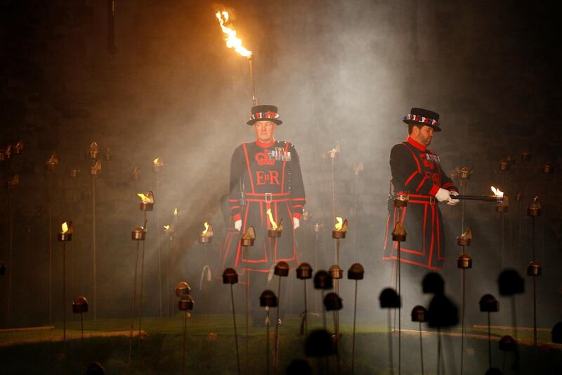 Yeoman of the Guard light the first torches that are part of the installation 'Beyond the Deepening Shadow' at the Tower of London. Reuters