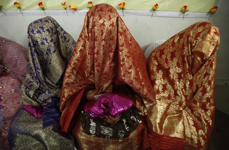 Brides sit together during a mass wedding ceremony in Peshawar. A total of 25 couples from the Pakistan’s northwest province of Khyber Pakhtunkhwa participated in the ceremony, organised by Al-Khidmat Foundation, a welfare organisation of Pakistan’s political and religious party Jammat-e-Islami. Fayaz Aziz / Reuters / April 25, 2014