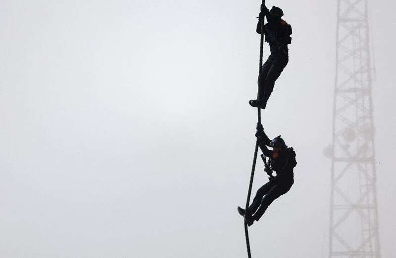 Troops descend ropes in the exercise called Lion's Leap.