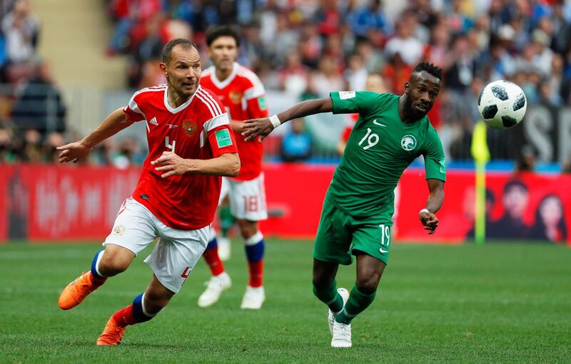 epa06807795 Sergei Ignashevich (L) of Russia in action against Fahad Al-Muwallad (R) of Saudi Arabia during the FIFA World Cup 2018 group A preliminary round soccer match between Russia and Saudi Arabia in Moscow, Russia, 14 June 2018.

(RESTRICTIONS APPLY: Editorial Use Only, not used in association with any commercial entity - Images must not be used in any form of alert service or push service of any kind including via mobile alert services, downloads to mobile devices or MMS messaging - Images must appear as still images and must not emulate match action video footage - No alteration is made to, and no text or image is superimposed over, any published image which: (a) intentionally obscures or removes a sponsor identification image; or (b) adds or overlays the commercial identification of any third party which is not officially associated with the FIFA World Cup)  EPA/YURI KOCHETKOV   EDITORIAL USE ONLY