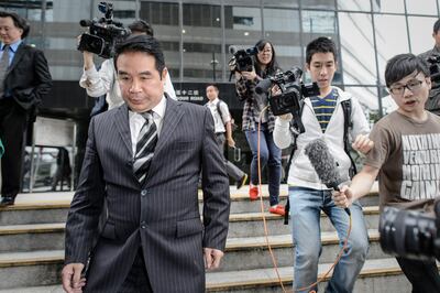 Birmingham City owner Carson Yeung (L) leaves the Wanchai district court in Hong Kong on April 29, 2013. Yeung insisted he made his fortune through legitimate stock trading as he pleaded not guilty to money-laundering charges in court on April 29 at the long-delayed start of his trial.  AFP PHOTO / Philippe Lopez / AFP PHOTO / PHILIPPE LOPEZ