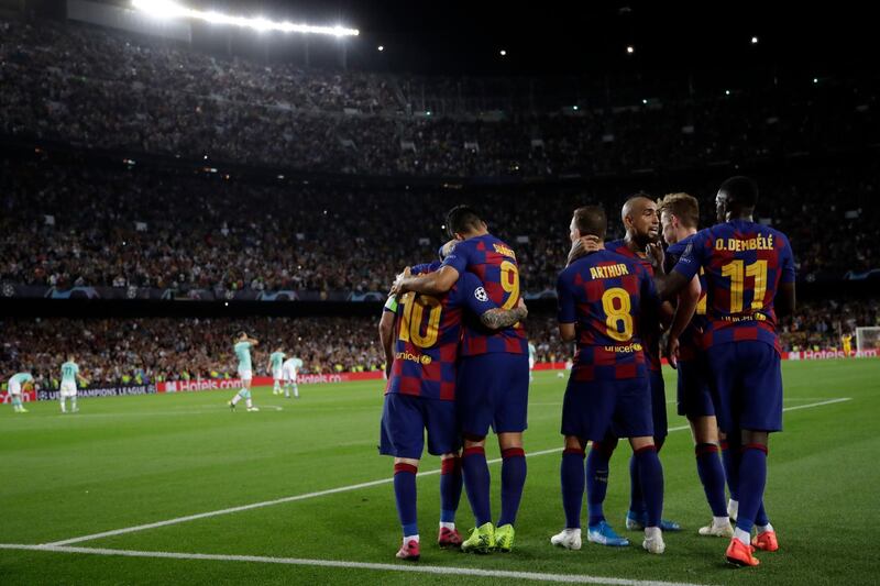 Barcelona players celebrate their side's second goal. AP Photo