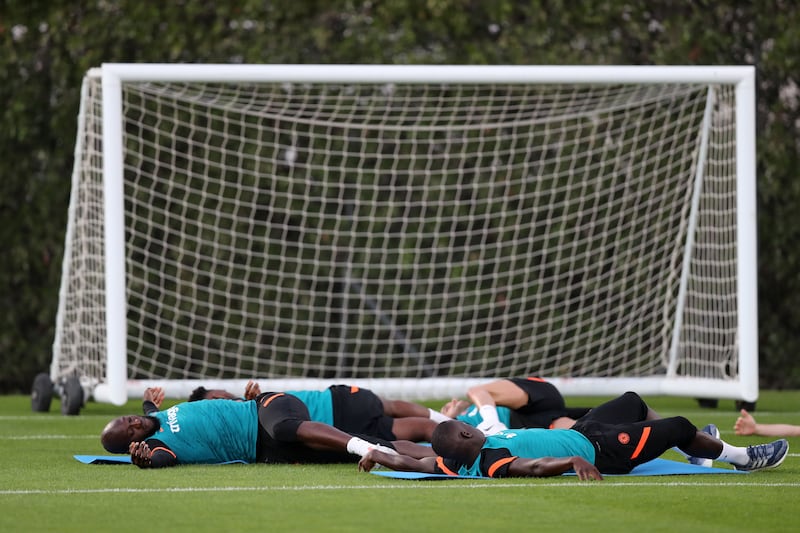 Chelsea striker Romelu Lukaku stretching with teammates.