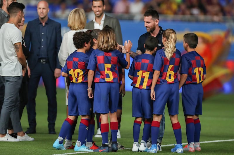 Messi shakes hands with young Barcelona players. Getty