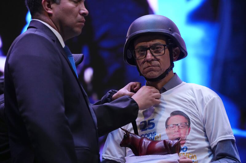 Presidential hopeful Christian Zurita, who was named to replace the assassinated Fernando Villavicencio, has his clothing adjusted during his closing campaign rally in Quito, Ecuador. AP