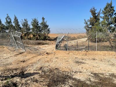 The broken gate where Hamas broke into Kfar Aza. Behind it is Gaza, only 2km  away. The National