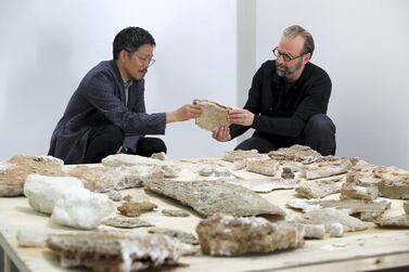 Kenichi Teramoto and Wael Al Awar examine minerals,​​​​​​ collected for their 'Wetlands' exhibition at Alserkal Avenue in Dubai. Pawan Singh / The National