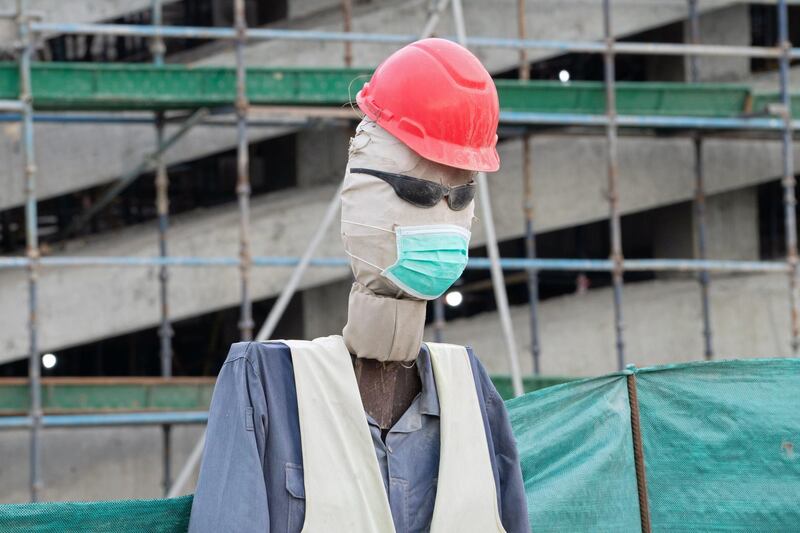 A life-sized dummy dressed in a safety gear and a protective mask is seen on a construction worksite, following the outbreak of the coronavirus disease (COVID-19), in Ahmadi, Kuwait. Reuters