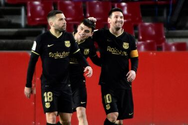 Barcelona's striker Lionel Messi celebrates with teammates Pedri and Jordi Alba after scoring in the 4-0 La Liga win at Granada. EPA