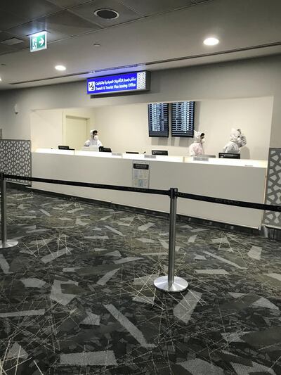 Inside the medical testing area, passengers must register at a desk staffed by a team sporting face masks and full protective body suits.