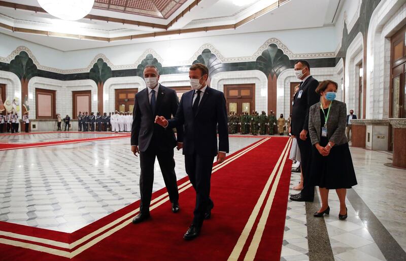 French President Emmanuel Macron, centre right, and Iraqi Prime Minister Mustafa Al Kadhimi, head for a meeting in Baghdad. AP