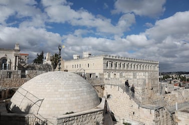 Tourists walk by the Christian Quarter at the Walls Promenade on the walls of the Old City of Jerusalem. EPA