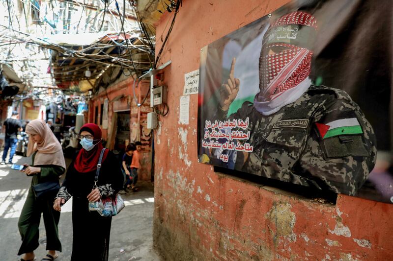 Palestinian refugees walk in an alley of the Shatila camp. AFP