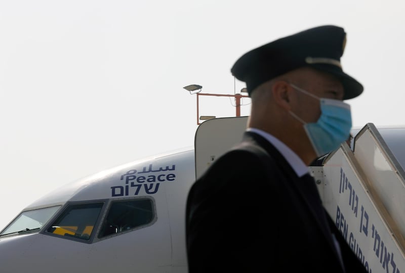 A flight crew member stands in front of the El Al jet. AP