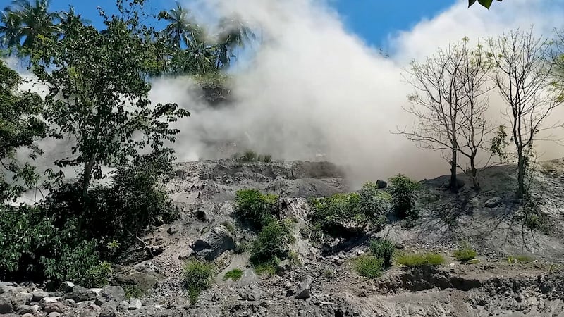 A dust cloud forms on a hill in Nagekeo, Indonesia, after the earthquake. The country's meteorological agency issued a tsunami warning. Reuters