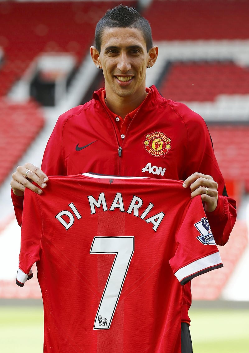 Manchester United's new signing Angel Di Maria poses for a photograph with his shirt at Old Trafford in Manchester, northern England  August 28, 2014.  Manchester United have signed Di Maria from Real Madrid for a British record transfer fee of almost 60 million pounds ($99.40 million).  REUTERS/Darren Staples   (BRITAIN - Tags: SPORT SOCCER)