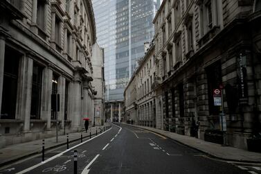 A person walks through empty streets in the City of London during the third lockdown. Associated Press