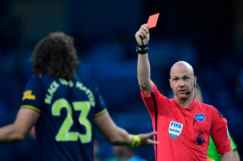 Referee Anthony Taylor shows a red card to Arsenal's Brazilian defender David Luiz. AFP