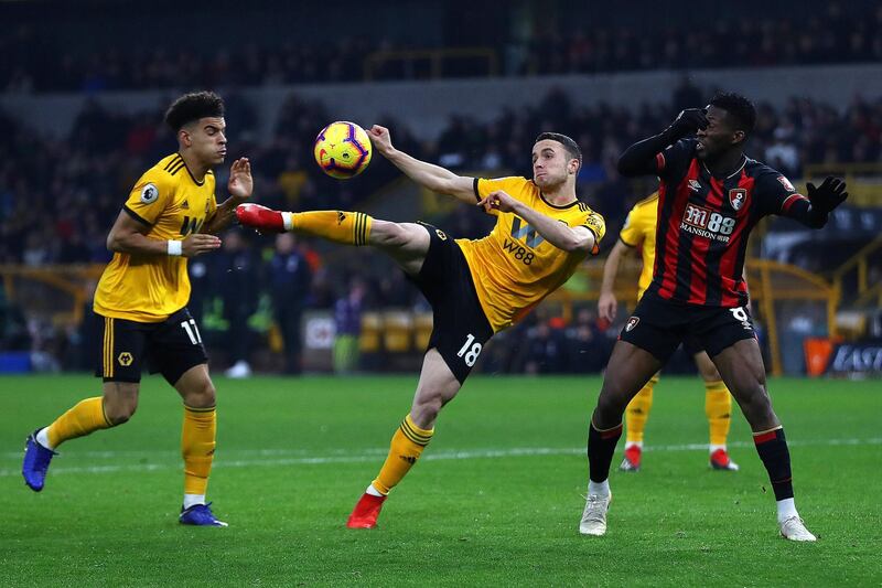 WOLVERHAMPTON, ENGLAND - DECEMBER 15:  Dioga Jota of Wolverhampton shoots as Jefferson Lerma of Bournemouth challenges during the Premier League match between Wolverhampton Wanderers and AFC Bournemouth at Molineux on December 15, 2018 in Wolverhampton, United Kingdom. (Photo by Michael Steele/Getty Images)