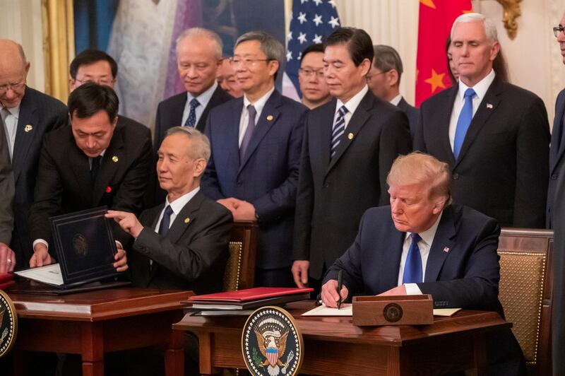 epa08131195 US President Donald J. Trump (R) and Chinese Vice Premier Liu He (L) participate in a signing ceremony of a China trade agreement in the East Room of the White House in Washington, DC, USA, 15 January 2020. The pact should ease trade tensions between the two superpowers.  EPA/ERIK S. LESSER