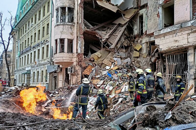 Rescuers work at a building damaged by an air strike, in central Kharkiv, Ukraine. Reuters