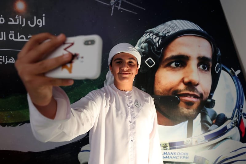 People attend a live screening of the launch of the UAE's first astronaut into space, at Mohammed bin Rashid Space Centre in Dubai. Chris Whiteoak / The National