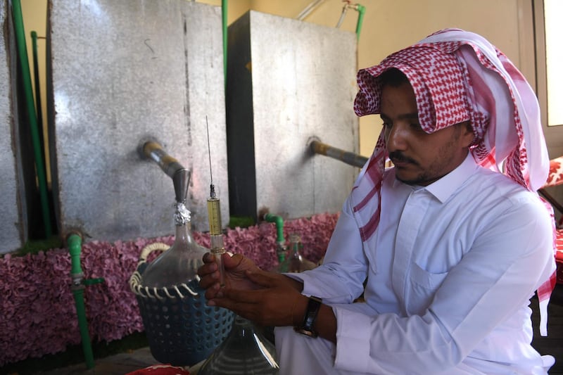 Salman displays a syringe of distilled Taif rose oil. AFP