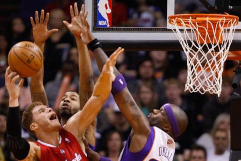Los Angeles Clippers' Blake Griffin goes up against Markieff Morris and Jermaine O'Neal of the Phoenix Suns.