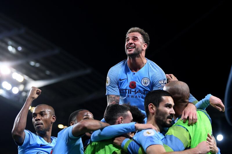 Ilkay Gundogan of Manchester City (second right) celebrates with teammates after scoring his team's third goal during the Premier League match between Manchester City and Manchester United. Getty