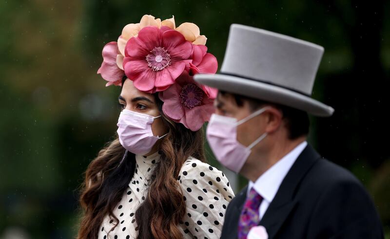Racegoers wear face masks as they arrive for day four of Royal Ascot at Ascot Racecourse. Steven Paston/PA Wire.