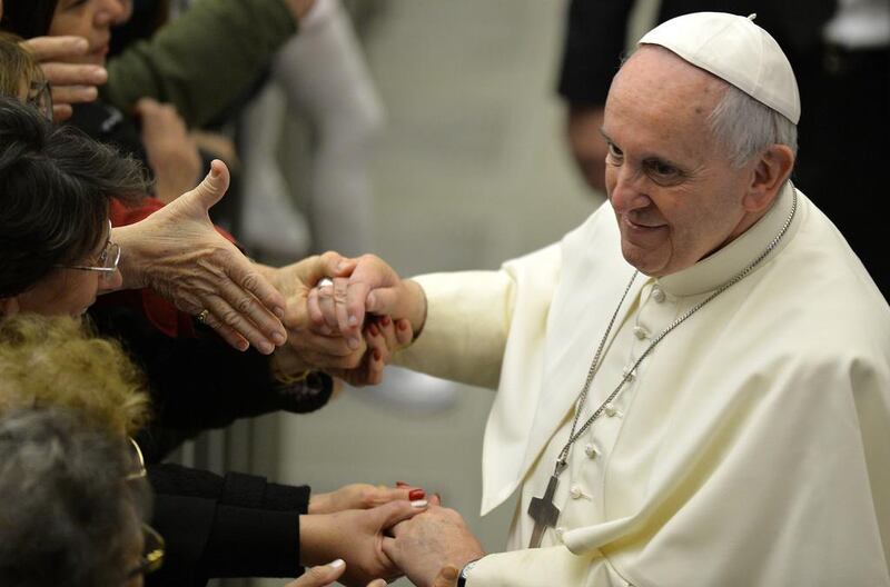 Pope Francis greets the crowd during his audience to Vatican employees. Andreas Solaro / AFP