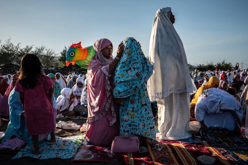 Women attend Eid Al Fitr prayer on 'sea of sands' at Parangkusumo beach in Yogyakarta, Indonesia.  Ulet Ifansasti / Getty Images